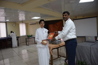 Presenting a Token of Appreciation to the Director of NATMO